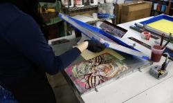 Photo of student making an art print