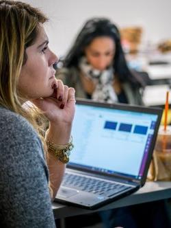 female student at desk with laptop