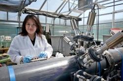 Meiyin Wu working on equipment in a lab.